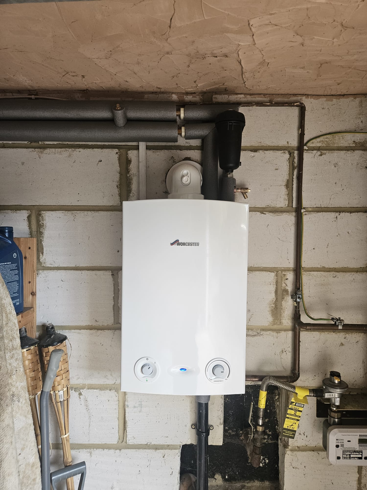Annual boiler service on a Worcester Greenstar combi boiler with gas safety tag, Surrey
