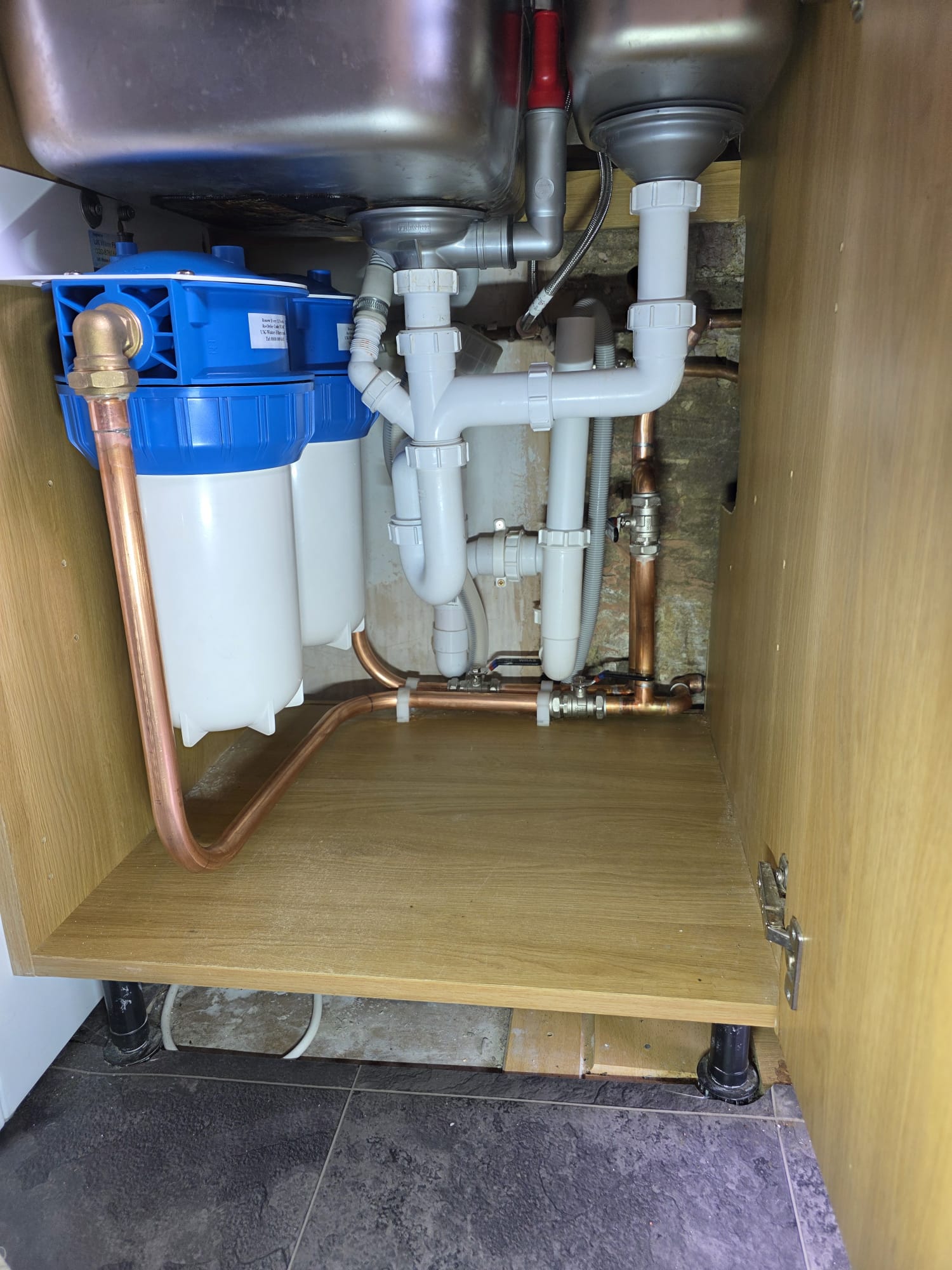 Under-sink plumbing rebuild with twin water filter housing, isolation valves and tidy copper pipework, Surrey